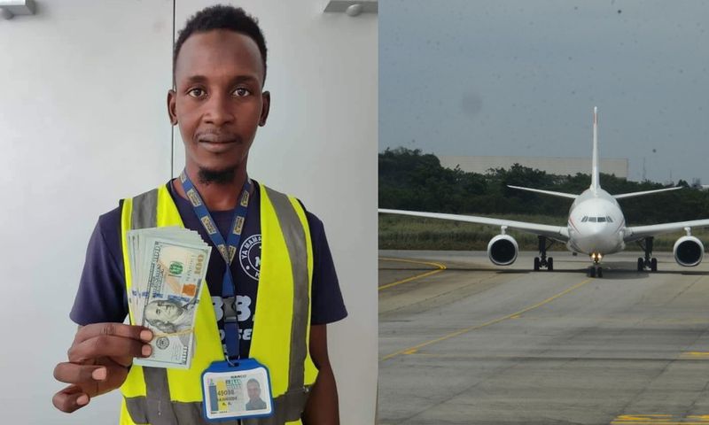 Auwal Dankode, a cleaner at Malam Aminu Kano International Airport in Kano displaying the dollar notes he found inside the plane. [Getty Images/X]