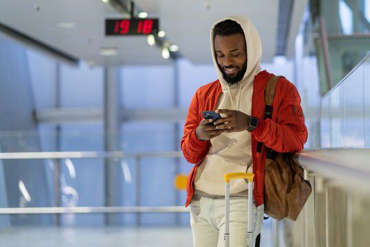 Black man at airport [Adobe Stock]