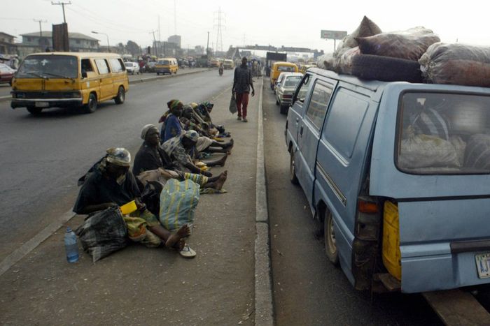 Beggars sit on Lagos Ikorodu highway 06 February 2006. Lagos is reputed as one of the mostly densely populated city in the world with population more than 14 million. [Getty Images]
