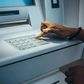 Black woman at an ATM [Shutterstock]
