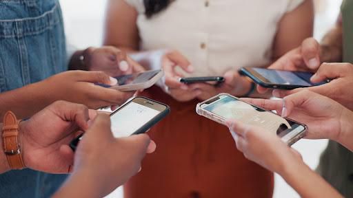 A photo of people using their phones