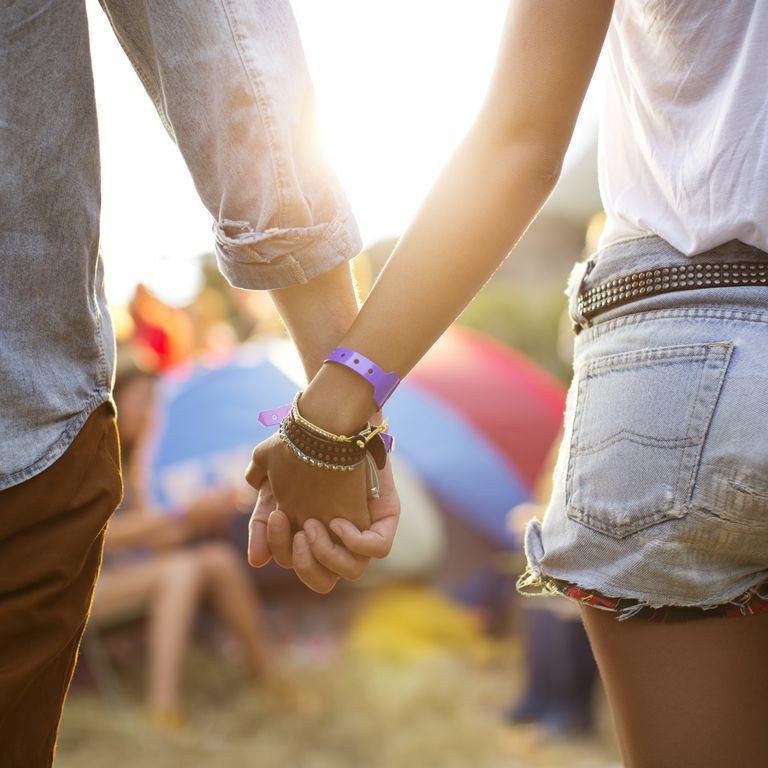 ___9178733___2018___12___7___19___couple-holding-hands-near-tents-at-music-festival-royalty-free-image-483597191-1543951609