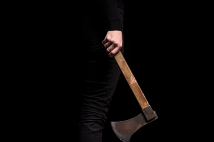 A female holding an axe [Shutterstock]
