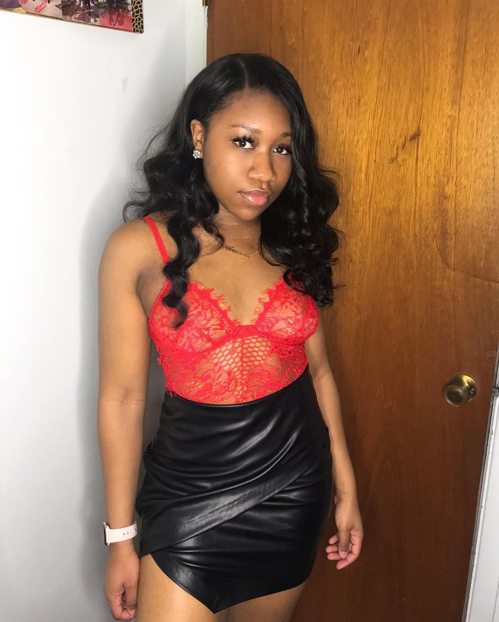 Red bodysuit paired with a black faux leather skirt (Instagram amariaruthh)