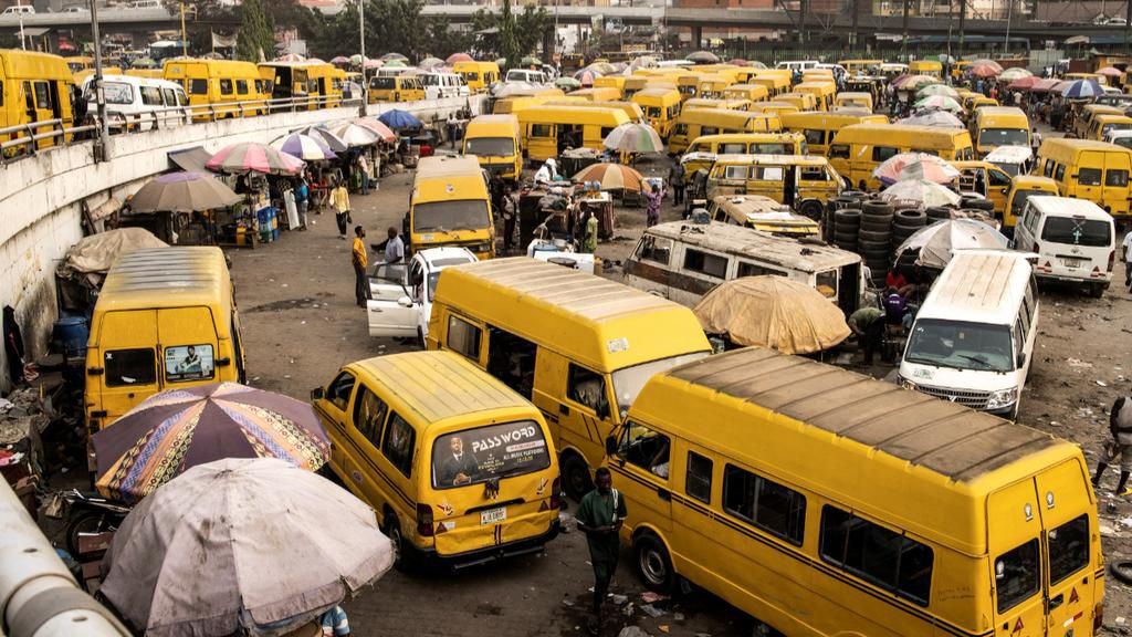 Yellow Danfo taxi drivers wait for customers at the Obalende bridge in Lagos on February 20, 2023, five days ahead of the Nigerian presidential election. [Getty Images]