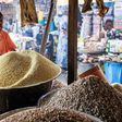 A trader waits for costumers while selling grains, legumes and flours in his stall at a market in the Obalende area of Lagos on December 18, 2023. [Getty Images]