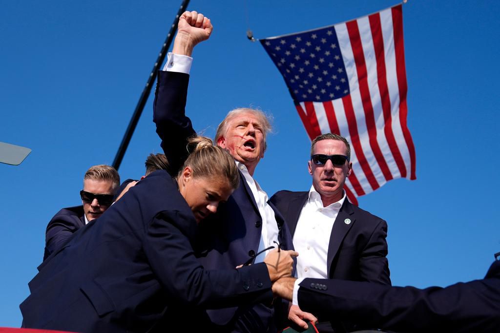 Trump appeared to be bleeding from the ear when he was escorted off stage following loud pops that rang out during a rally in Pennsylvania.