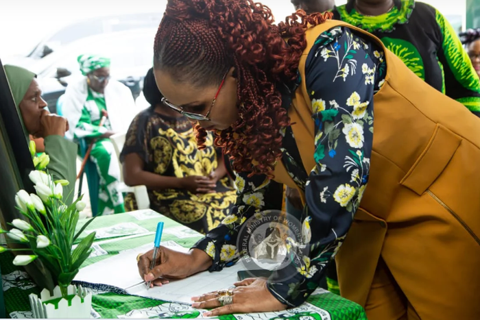Mrs Uju Kennedy-Ohanenye, Minister of Women Affairs, signing a condolence register at the National Council of Women Societies (NCWS) headquarters on Wednesday in Abuja.