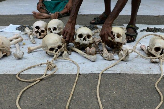 An Indian farmer from Tamil Nadu state arranges human skulls, said to belong to farmers who had committed suicide, during a protest in New Delhi on August 1, 2017