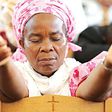 A woman praying on her knees [The Guardian Nigeria]