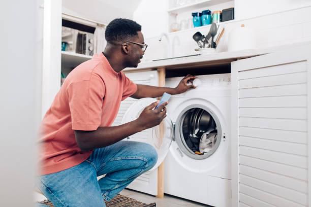 Black man doing laundry [iStock]