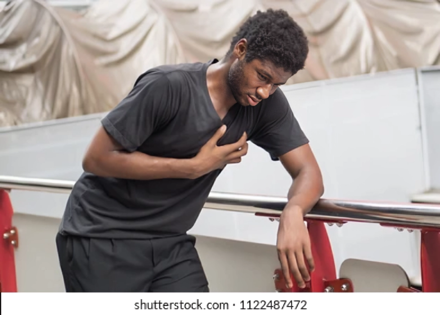 A stock photo of someone posing like they suffered a heart attack