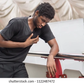 A stock photo of someone posing like they suffered a heart attack