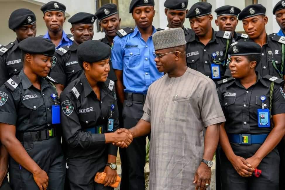 Yahaya Bello greeting police officers.