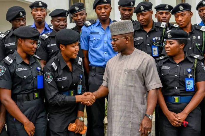 Yahaya Bello greeting police officers.