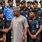 Yahaya Bello greeting police officers.