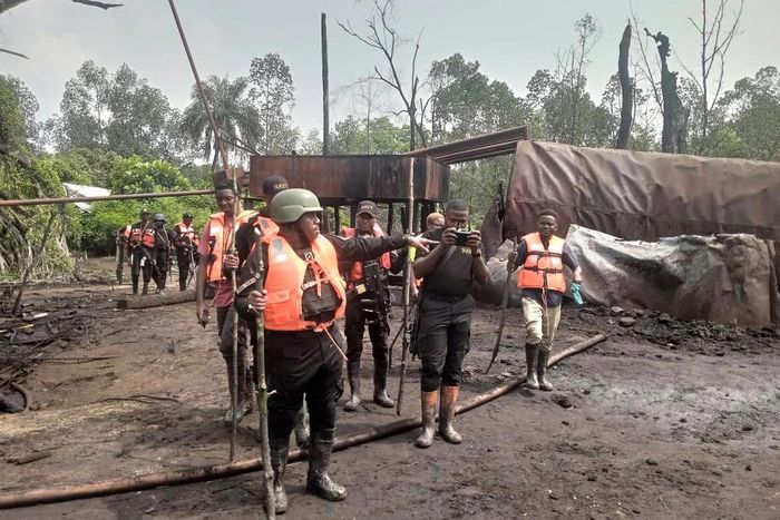 Commander of NNS Pathfinder, Commodore Desmond Igbo, taking newsmen around illegal refinery in Rivers State [NAN]