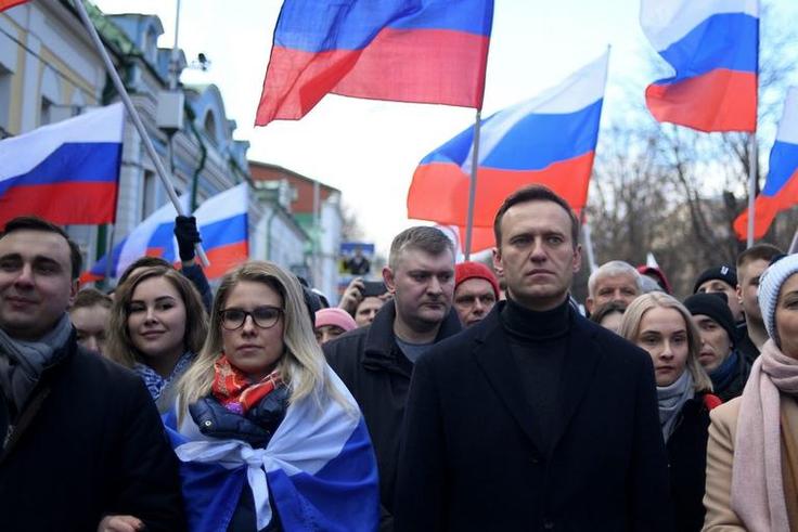 Russian opposition leader Alexei Navalny and his wife Yulia walk with demonstrators during a 2020 march in memory of murdered Kremlin critic Boris Nemtsov in downtown Moscow. He suffered a life-threatening poisoning months later, in August 2020.KIRILL ...