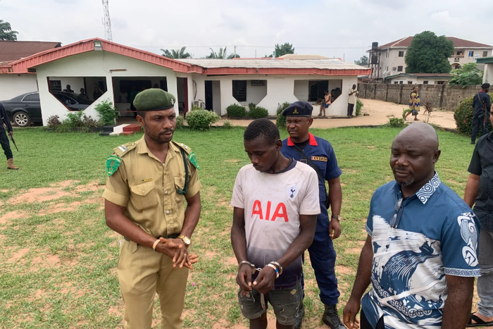 Re-arrested prison escapee, Chinonso Kalu (c) being handed over to the NCoS by the NSCDC in Owerri on Friday [NAN]