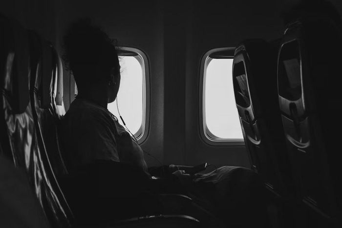 Black woman on a plane [Unsplash]