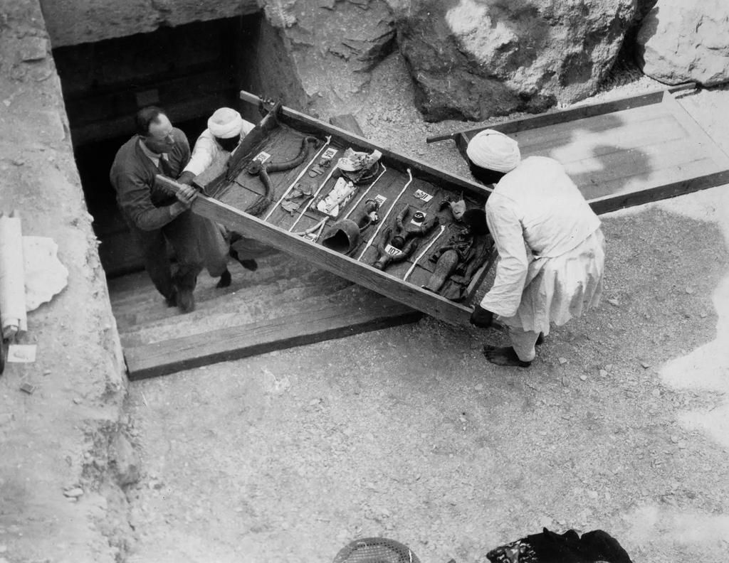 Workers remove a tray of chariot parts from the Tomb of Tutankhamun in the Valley of the Kings, Egypt, in 1922 [Getty]