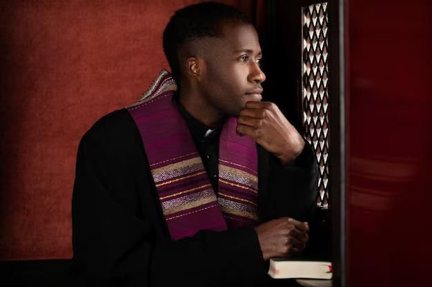Black priest inside confessional booth [Freepik]