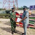 Lt Cdr. Bitus Zoaka, the Base Operating Officer, representing the Commanding Officer, Forward Operating Base of Nigerian Navy, Badagry hands over papers and unspecified number of foreign rice seized by the command to DC ID Musa, the Officer in Charge o...