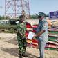 Lt Cdr. Bitus Zoaka, the Base Operating Officer, representing the Commanding Officer, Forward Operating Base of Nigerian Navy, Badagry hands over papers and unspecified number of foreign rice seized by the command to DC ID Musa, the Officer in Charge o...