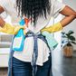 Black woman cleaning an apartment [Adobe Stock]