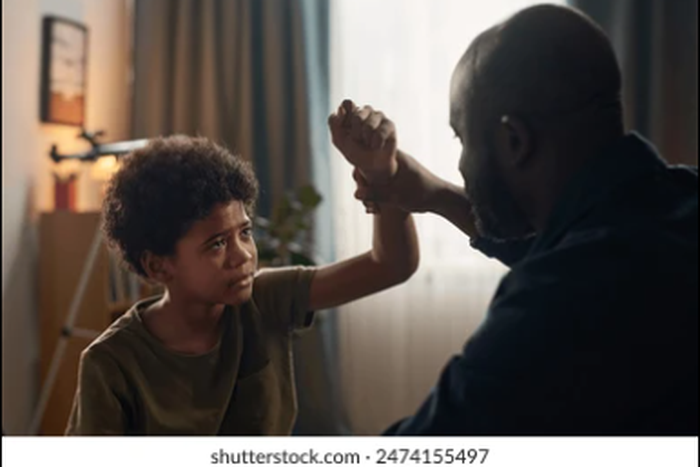 Father beating son [Shutterstock]