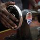 A former child soldier receives a sewing machine to help set up a business after finishing training as a tailor