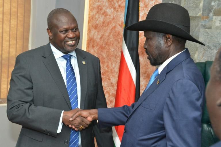 Handshake: President Salva Kiir, right, and ex-vice president and former rebel leader Riek Machar at their meeting on Wednesday