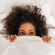 Black woman in bed [iStock]