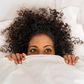 Black woman in bed [iStock]