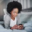 Black woman in bed [iStock]
