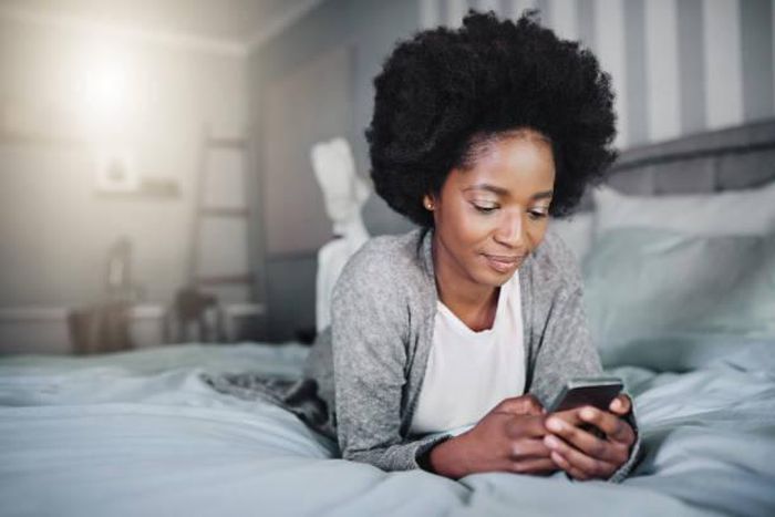 Black woman in bed [iStock]