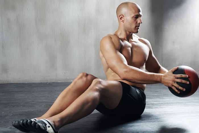 A man doing Russian twists