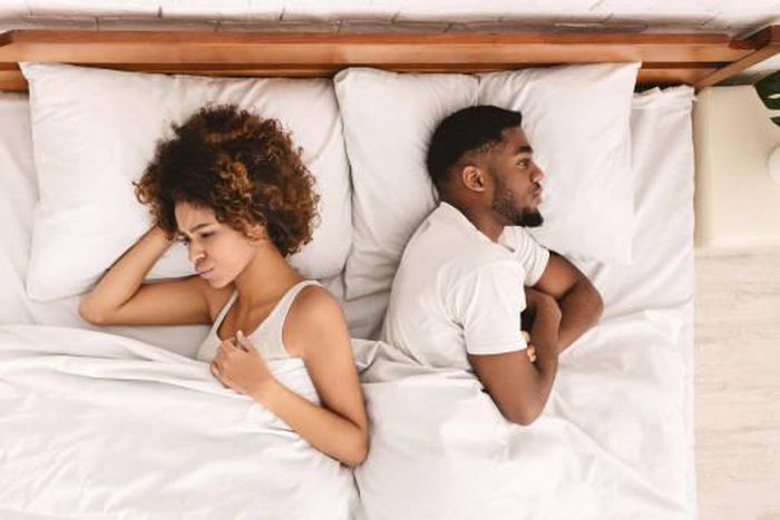 Frustrated Black couple in bed [iStock]