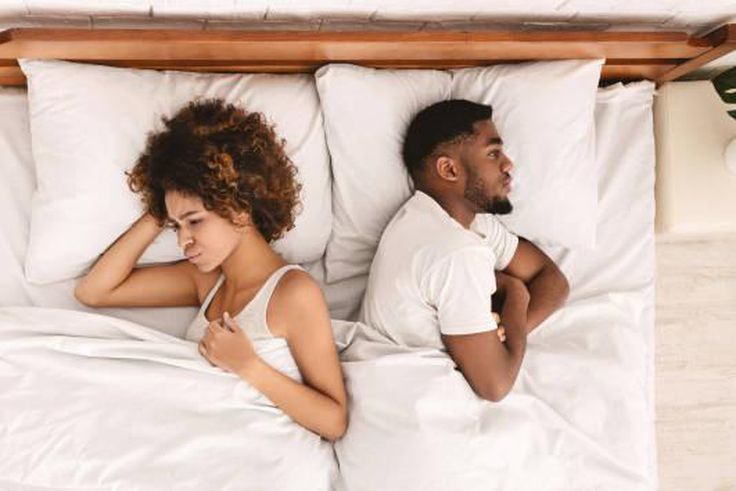 Frustrated Black couple in bed [iStock]