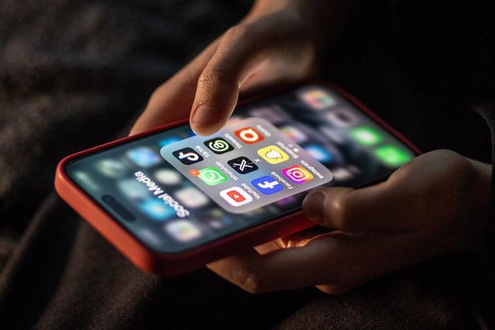 iPhone screen showing various social media apps including TikTok, Facebook and X.Matt Cardy