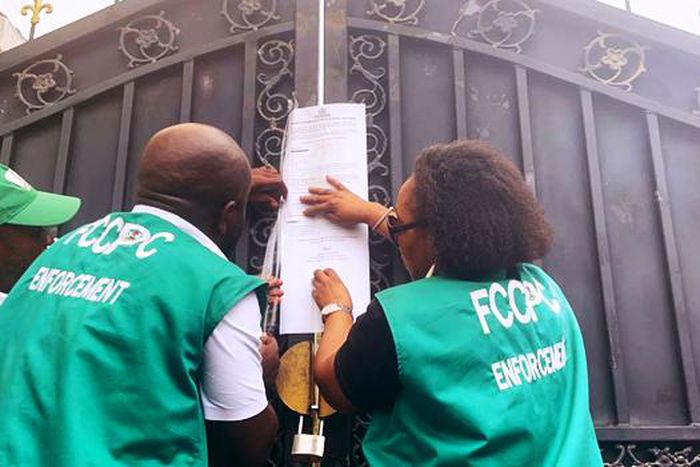 Officials of the FCCPC seal up a Chinese supermarket in Abuja.