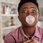 Black woman chewing gum [Adobe Stock]