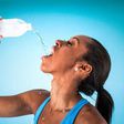 Sports woman drinking water