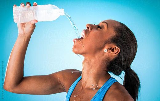 Sports woman drinking water