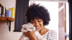 A woman having a good time with a cat