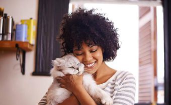A woman having a good time with a cat