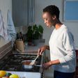 Black woman cooking in the kitchen [Pik Wizard]