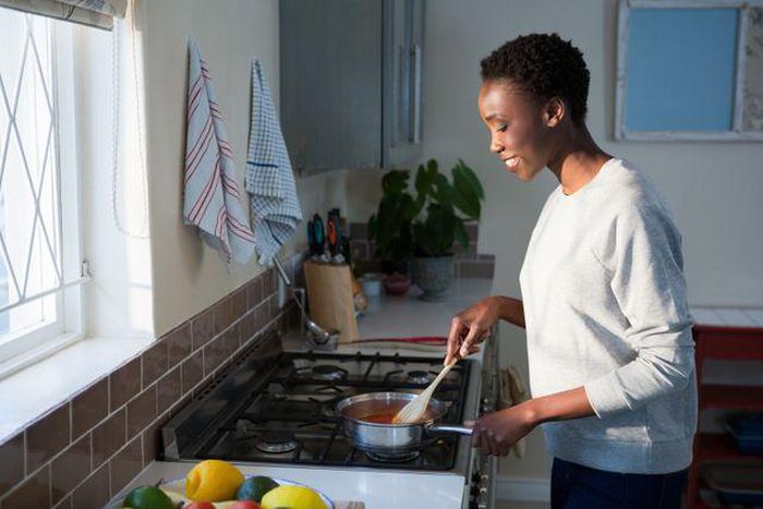 Black woman cooking in the kitchen [Pik Wizard]