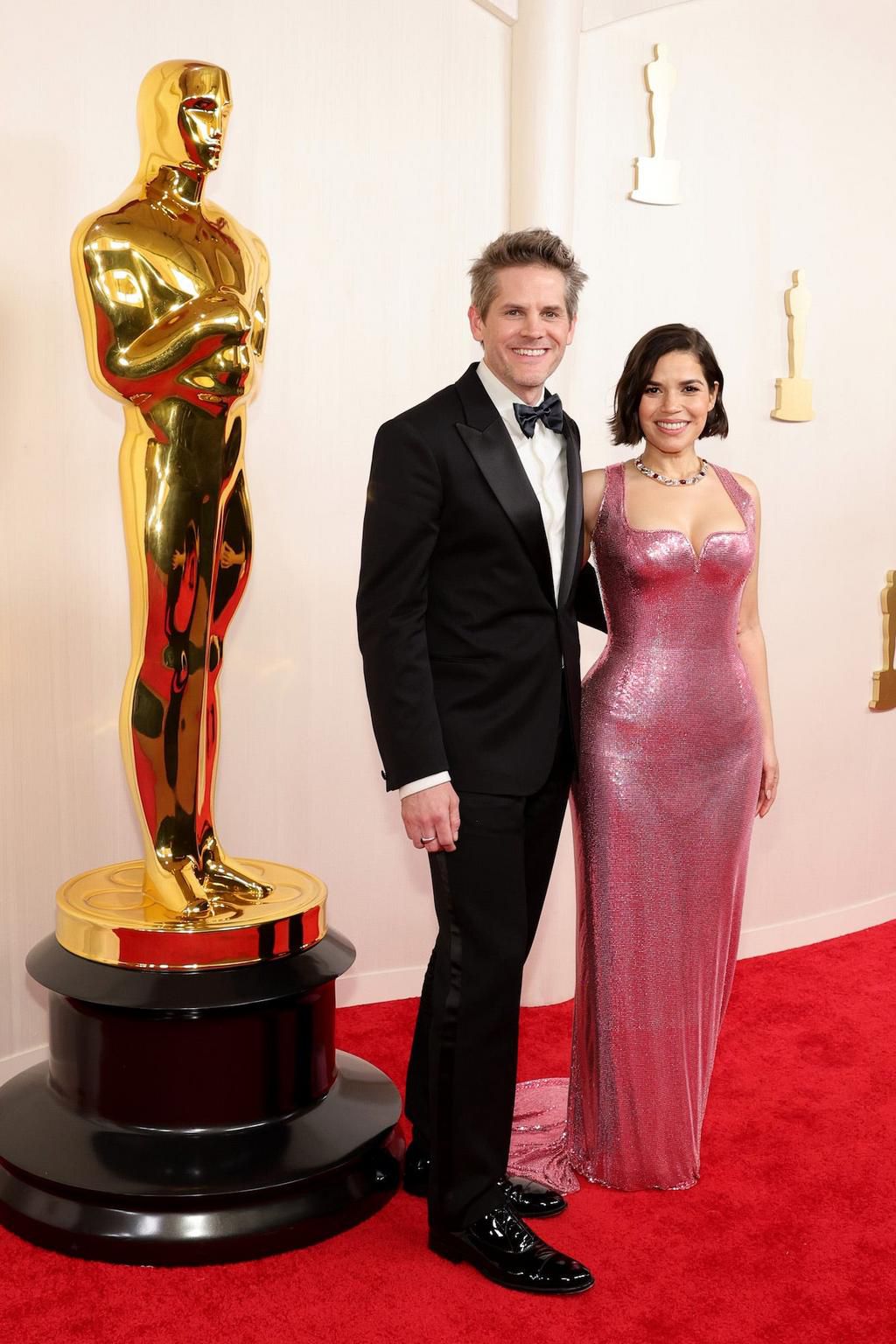America Ferrera brought Barbie pink to the red carpet, while her husband, Ryan Piers Williams, kept it simple with a black tux.
