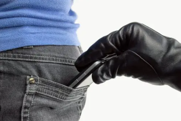 A thief stealing a phone [Daily Post Nigeria]